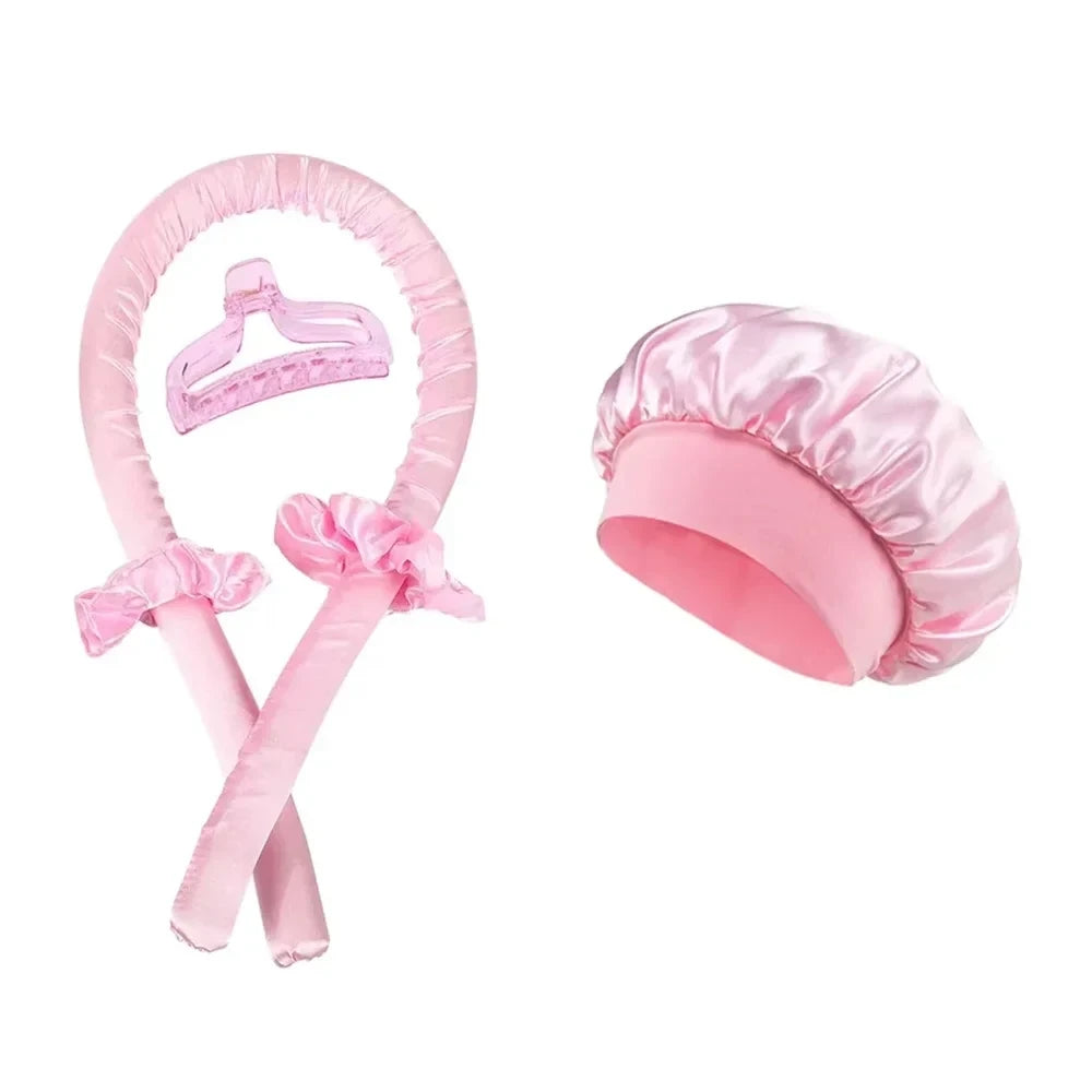Seraphic heatless hair curling set in light pink satin with a matching curling rod, two scrunchies, clip, and bonnet.